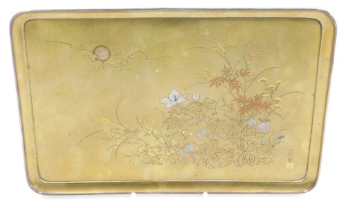 A Meiji period hirazogan bronze tray, inlaid in gold, silver and copper with flowers and grasses under a full moon and clouds, raised on four bracket feet, signed, 22.5cm wide.