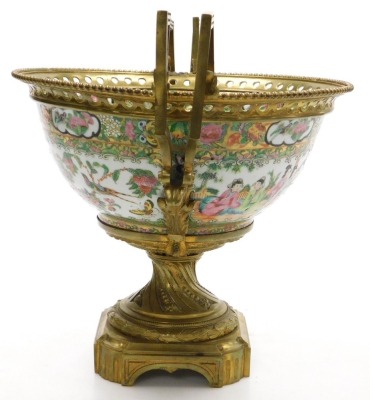 A 19thC Cantonese famille rose porcelain and ormolu mounted bowl, with a beaded and pierced mount and angular scroll handles, the bowl decorated with reserves of figures, and birds, butterflies and flowers, within a gilt ground decorated with fruit, flowe - 2