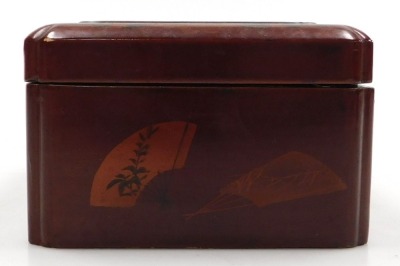 An early 20thC Japanese red lacquer box, of rectangular section, the hinged lid decorated in relief with a flying duck, flower and grasses, 19cm wide, 15cm deep, together with a black and gilt lacquer bowl decorated with a theatrical scene and onlookers, - 6