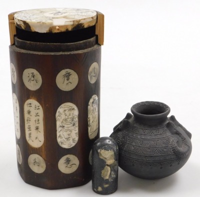 A Japanese black pottery vase, with double serpent handles, and carved with geometric banding, two character impressed mark, 12cm wide, together with a Chinese bamboo and bone inlaid octagonal brush pot and cover, 18cm high, and a hardstone seal. (3)