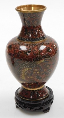 A Chinese red ground cloisonne vase, with stand, of baluster form, decorated with Imperial dragons chasing a flaming pearl, 20cm high, vase decorated with flowers on a black ground, 15.5cm high, and a vase decorated with peacocks on a blue ground, 15.5cm - 3