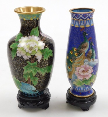 A Chinese red ground cloisonne vase, with stand, of baluster form, decorated with Imperial dragons chasing a flaming pearl, 20cm high, vase decorated with flowers on a black ground, 15.5cm high, and a vase decorated with peacocks on a blue ground, 15.5cm - 10