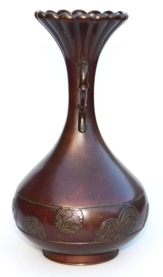 A Meiji period bronze vase, of fluted, and twin handled, baluster form, the body with a band embossed with prunus blossom and floral roundels, three character signature to base, 24.5cm high. - 2