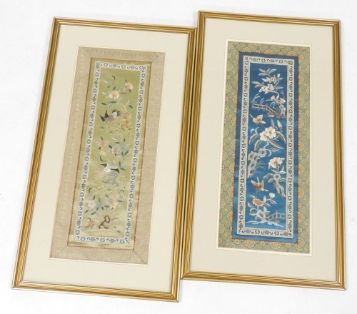 Two framed Chinese silk sleeve bands, one embroidered with butterflies and flowers in a fenced garden, on a blue ground, the other with exotic birds and flowers on a pale green ground, each 56cm x 22.5cm.