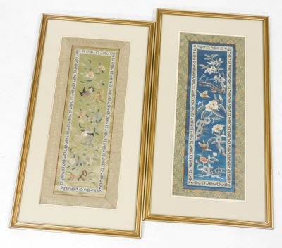 Two framed Chinese silk sleeve bands, one embroidered with butterflies and flowers in a fenced garden, on a blue ground, the other with exotic birds and flowers on a pale green ground, each 56cm x 22.5cm.