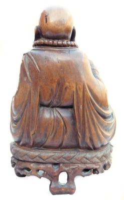 A late 19thC Chinese hardwood carving of a Buddha, seated on a lotus flower, 33cm high, and a pair of carvings of two women bat catchers, one seated, the other standing upon a shell, within a surround of bats and clouds, 38cm high. (3, AF) - 4