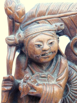 A late 19thC Chinese hardwood carving of a Buddha, seated on a lotus flower, 33cm high, and a pair of carvings of two women bat catchers, one seated, the other standing upon a shell, within a surround of bats and clouds, 38cm high. (3, AF) - 14