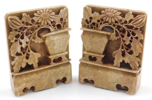 A pair of Chinese soapstone bookends, each carved as a vase of flowers on a plinth base, 14cm high.