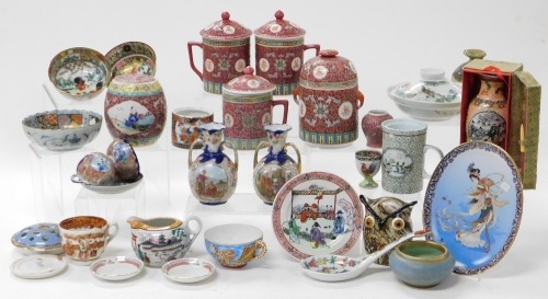 A group of Chinese and Japanese ceramics, etc., including red enamelled tankards and covers, jars and covers, rice bowl and cover, and a pair of Japanese vases. (a quantity)