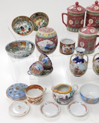 A group of Chinese and Japanese ceramics, etc., including red enamelled tankards and covers, jars and covers, rice bowl and cover, and a pair of Japanese vases. (a quantity) - 2