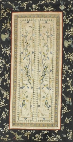 A pair of 19thC Chinese silk sleeve bands, embroidered with birds and flowers on a cream ground, floral mount in faux gilt bamboo frame and glazed, 68.5cm x 38cm.