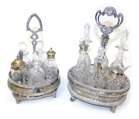 Two Victorian silver plated oval cruets, one containing six fitted jars and bottles, the other with five bottles and jars.