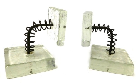 A pair of late 20thC Studio glass and cast iron bookends, of abstract geometric form, 16.5cm high.