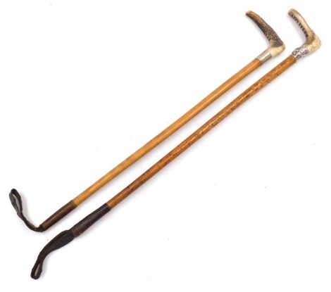 A Victorian horn handled riding crop, with a white metal ferule, armorial engraved and embossed with a fox's head, 74cm long, together with a further horn handled riding crop, 72cm long. (2)