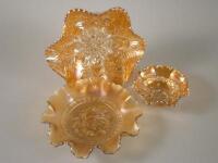 A marigold coloured Carnival glass dish moulded with flowers