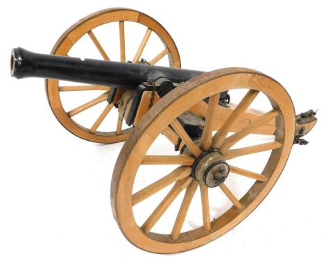 A wooden and cast iron scale model of a Napoleonic era canon, 70cm wide.