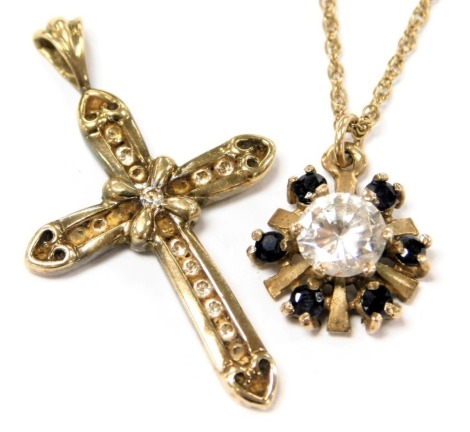 A 9ct gold and cz pendant cross, together with a 9ct gold sapphire and cz floral pendant on chain, 4.1g.