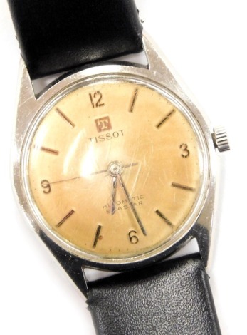 A Tissot Seastar stainless steel cased gentleman's wristwatch, circular champagne dial bearing Arabic numerals at quarters, centre seconds, on a leather strap.