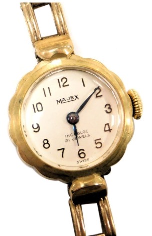 A Majex 9ct gold cased lady's wristwatch, circular silvered dial bearing Arabic numerals, Swiss 17 jewel movement, on a 9ct gold square link bracelet strap, cased, 13.2g.