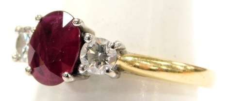 An 18ct gold ruby and diamond three stone ring, ruby approximately 0.75 carat, diamonds approximately 0.5 carat, size 0/P, 4.0g.