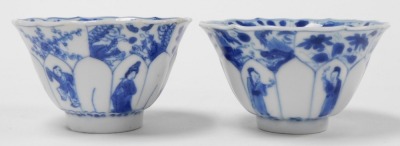 A pair of Kangxi porcelain blue and white tea bowls and saucers, of moulded floral form, decorated with figures beneath blossom and dragons, internally with a four claw dragon and panels of flowers, with stands. - 4