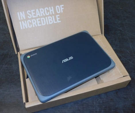 A Asus chrome book model C202X, boxed with charger.