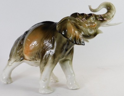 A Royal Dux porcelain figure, modelled as an elephant with raised trunk, printed marks, 33cm high. - 2