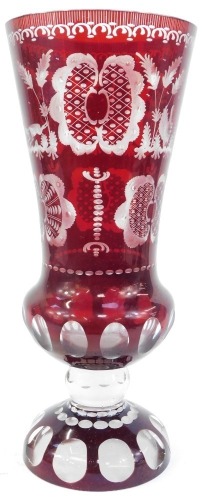 A Bohemian cut glass cranberry flash vase, of inverted trumpet form, on circular base with etched decoration of birds, leaves, etc., 40cm high. (AF)