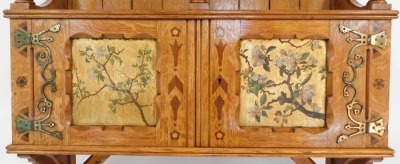 A late 19thC Gothic Revival oak hanging cupboard, the drawer stamped L W Collmann 2572, of architectural form, with sloping 'roof canopy' above an open shelf, with three turned column supports, the cupboard below enclosed by two doors with marquetry inlay - 3