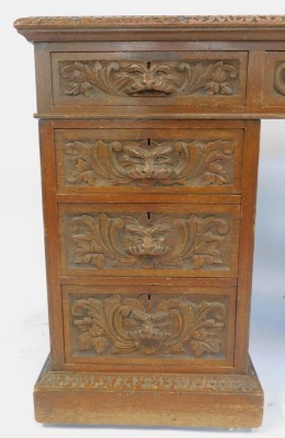 A Victorian carved oak twin pedestal desk, with leather top and carved mask head handles, 180cm x 82cm. - 3