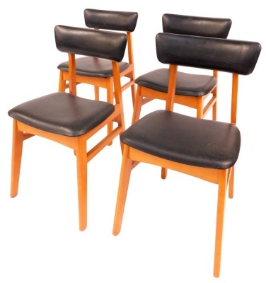 A set of four Schreiber dining chairs, each with a leatherette padded seat and back, on tapering legs. The upholstery in this lot does not comply with the 1988 (Fire & Fire Furnishing) Regulations, unless sold to a known exporter or upholsterer it will be