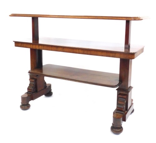 A Victorian mahogany metamorphic buffet, the top with a moulded edge raised on square end supports with scroll carving, on four bun feet on castors, 73cm high, the top 130cm x 54cm.