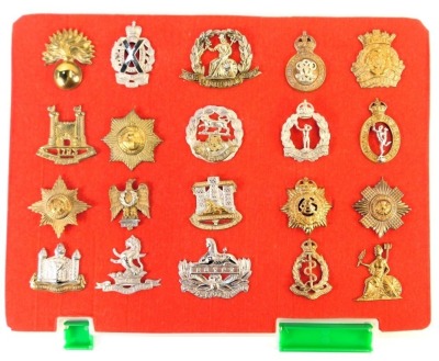 A group of military cap badges, to include Royal Army Medical Corps, 7th Dragoon Guards, Royal Corps of Signals, Royal Observer Corps, Royal Hampshire, Royal Norfolk Regiment etc. (20)