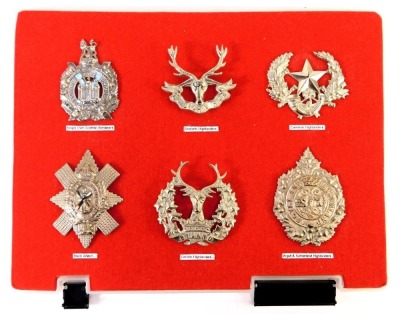 Six Scottish military cap badges, comprising King's Own Scottish Borders, Seaforth Highlanders, Cameron Highlanders, Black Watch, Gordon Highlanders and Argyll and Sutherland Highlanders.