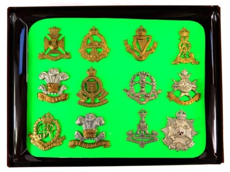 A group of military cap badges, to include Royal Army Ordnance Corps, Military Policemen, Fishguard, Nottinghamshire and Derbyshire Regiment, Yorkshire Regiment, etc. (12)