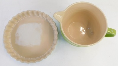 Two items of Le Creuset, comprising a green Le Creuset measuring cup, 12-02, 12cm high, and a turquoise oven ware flan dish, 1.35 litre, 25cm diameter. (2) - 2