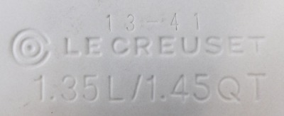 Two items of Le Creuset, comprising a green Le Creuset measuring cup, 12-02, 12cm high, and a turquoise oven ware flan dish, 1.35 litre, 25cm diameter. (2) - 3