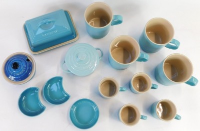 A group of Le Creuset homewares, comprising a set of four 0.35 litre light blue mugs, four 0.1 litre espresso mugs in pale blue, a turquoise butter dish and lid, and three pine dishes, and two miniature casserole dish. (1 tray) - 2