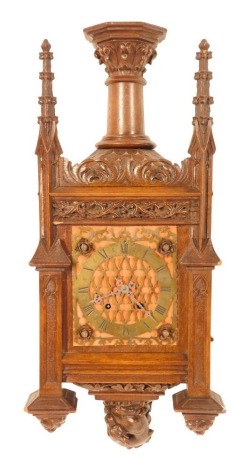 A late 19thC Neo-Gothic architectural oak cased wall clock, possibly Black Forest inspired by Johann Beha, with carved spires and turret top, foliate carving and carved pediment dragon, the brass dial with Roman numerals and open work scroll decoration, w