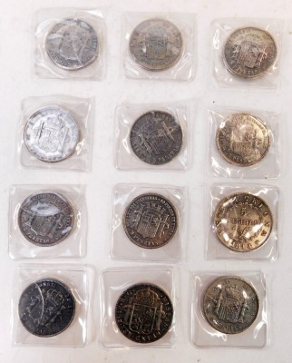 Nine replica Spanish five Pesetas coins for Alfonso XIII, dated 1888, 1892, 1899, 1891,1895 (x2), 1870, 1871 (x2), together with a five Pesetas coin for Alfonso XII dated 1881, a Ferdin VII coin for 1821, and a Barcelona five Pesetas coin dated 1814. (12) - 2