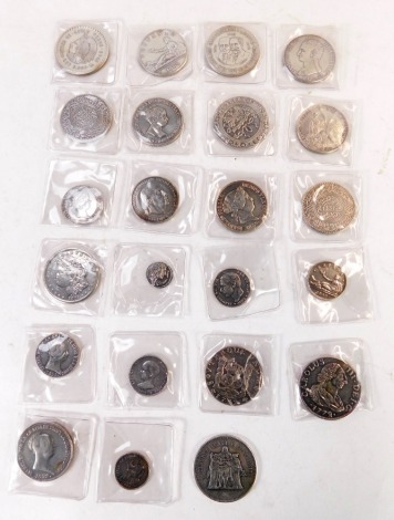 A group of replica Spanish and world coins, including Alfonso XII 1884, Isabelle 1860, 1855, a replica Carolus III 1772 reales coin, a replica 1893 Spanish coin, a 1921 American dollar, Mexican coins, fifty franc coin dated 1976, two replica Spanish reale