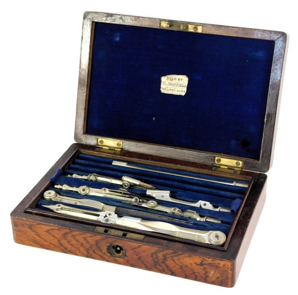 An early 20thC rosewood box, containing drawing instruments, the hinged ...