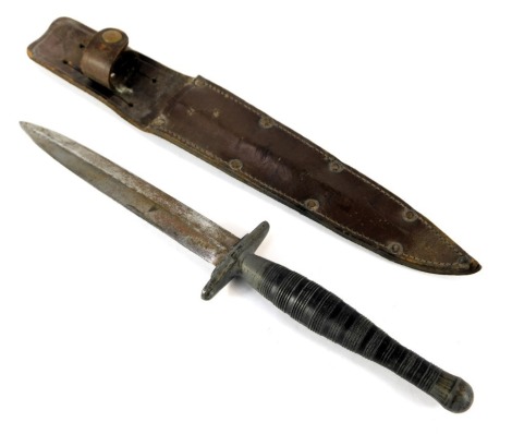 A scarce WWII period commando fighting knife, with alloy hilt and matt nickel finish to the handle, with leather sheath.