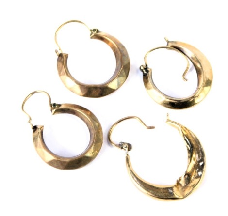 Four hoop earrings, each of hammered design, yellow metal unmarked, 3.2g. (AF)