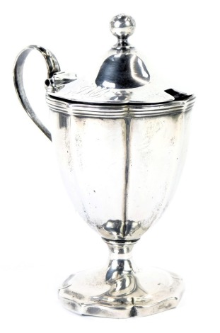 A William IV silver mustard pot and cover, with a ribbed border and a shaped handle, on a fluted base, with blue glass liner, lid bearing initials JMG, maker Abraham Peterson, London 1831, 4.25oz.