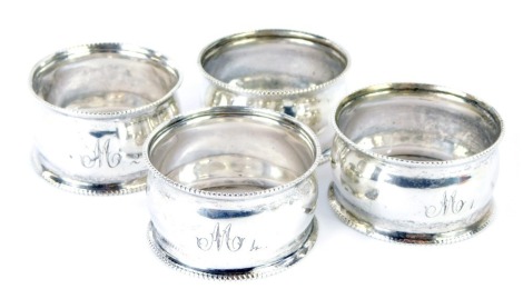 A set of four George VI silver napkin rings, each with a reeded border, bearing the initial M, Birmingham 1938, 1.61oz.