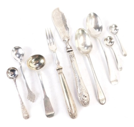 A group of silver and white metal cutlery, comprising Victorian silver fiddle pattern toddy ladle, two silver preserve spoons, a silver beaded teaspoon, silver flame topped teaspoon, silver handled and stainless steel pickle fork, etc., weighable silver 2