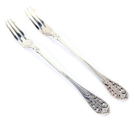 A pair of Victorian silver pickle forks, each with a pierced floral top and engine engraved decoration, maker Charles Boyton & Son, London 1891, 1.49oz. (2)