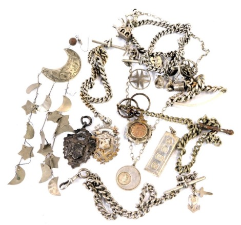 An assortment of silver, white metal and other jewellery, to include identity bracelet, watch chains, shield fobs, charm bracelet, silver ingot, etc. 8.65oz gross.