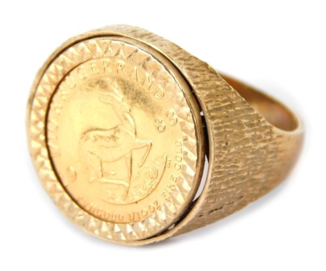 A 9ct gold coin set dress ring, with 1/10th Krugerrand, dated 1983, on a bark effect band, 7.2g all in.